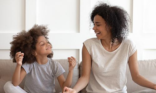 Mother and child sitting on couch