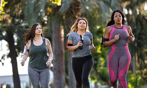 Three women jogging outside