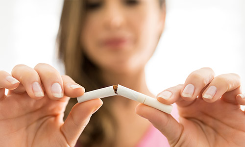 Woman breaking a cigarette